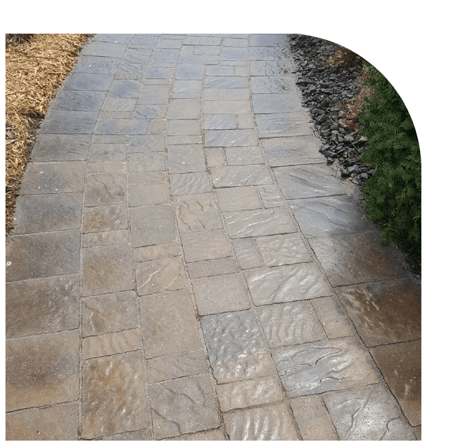 A walkway with stone tiles and gravel.