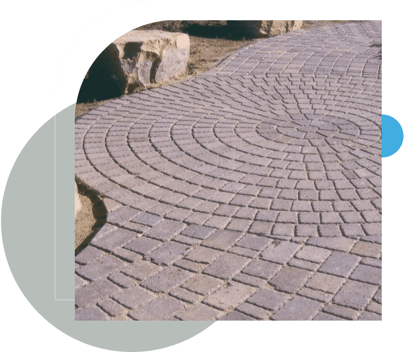 A close up of a brick walkway with green background