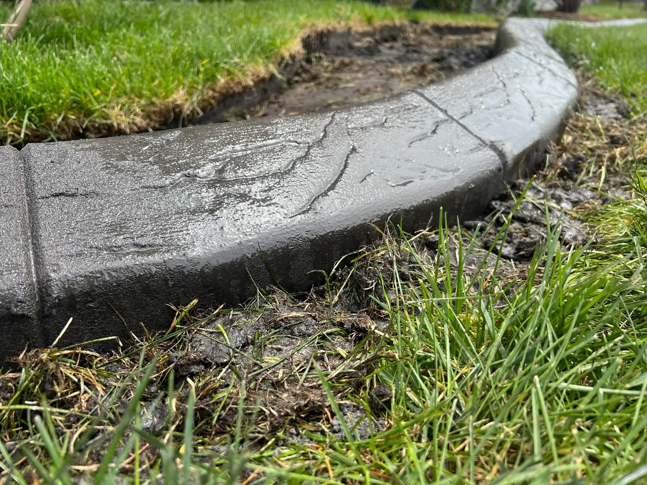 A close up of the edge of a concrete path