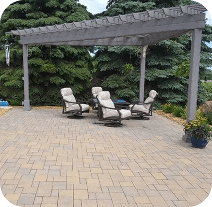 A patio with four chairs and a pergola.