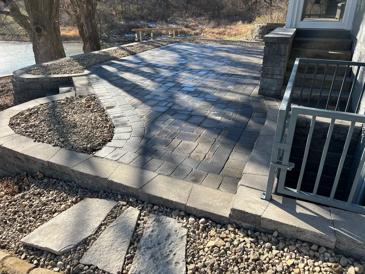A patio with steps and rocks in the middle of it.