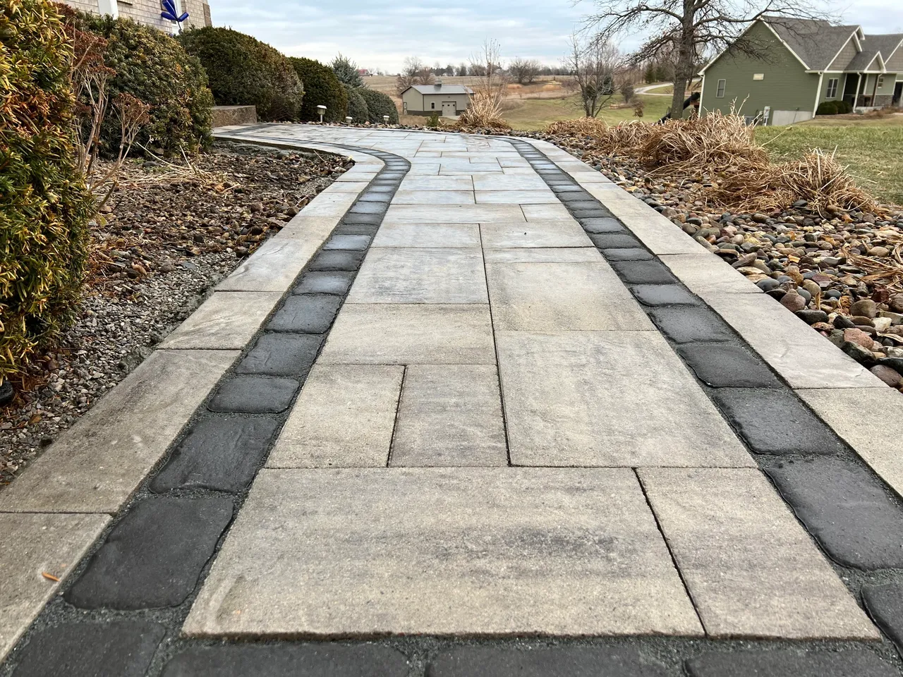 A walkway with black and white tiles on the sides.