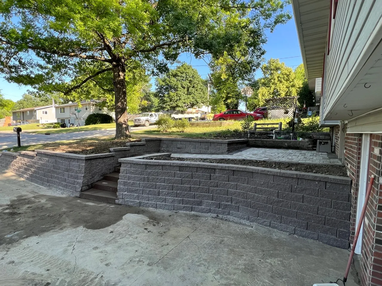 A large concrete block wall with steps leading to the ground.