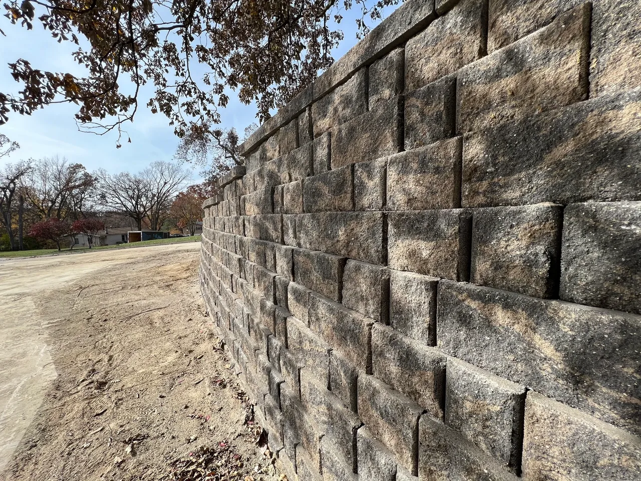 A brick wall with trees in the background